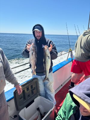 a couple of people standing next to a body of water