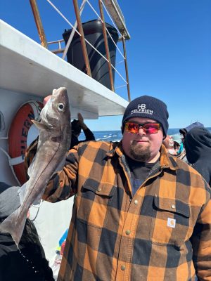 a man standing next to a stuffed animal