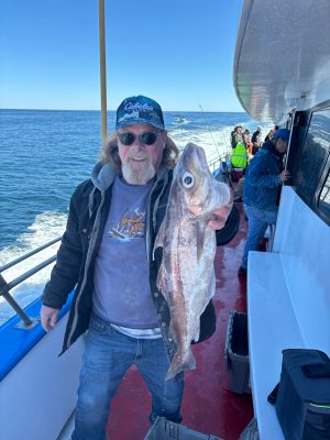a person holding a fish on a boat