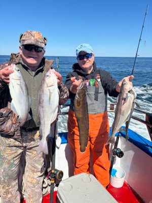 a person holding a fish on a boat