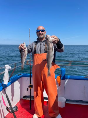 a person standing next to a body of water