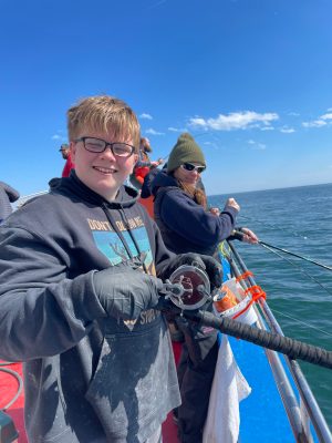 a person standing next to a body of water