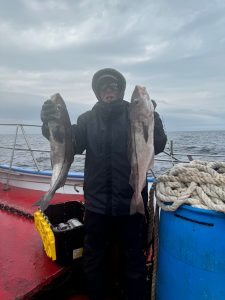 a person holding a fish in the water