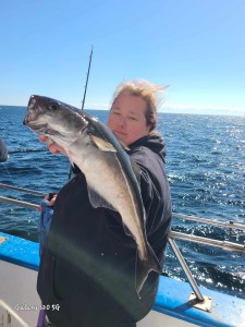 a person holding a fish in the water