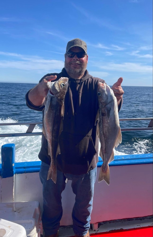 a man holding a fish in the water