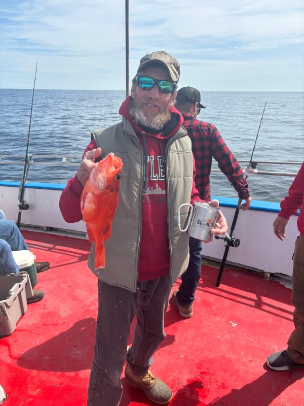 a person holding a fish in the water