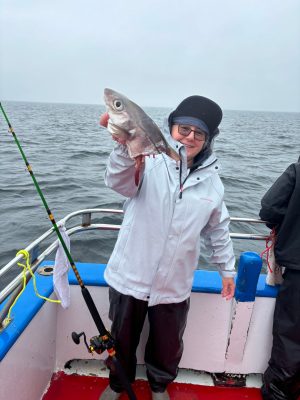 a person holding a fish in the water