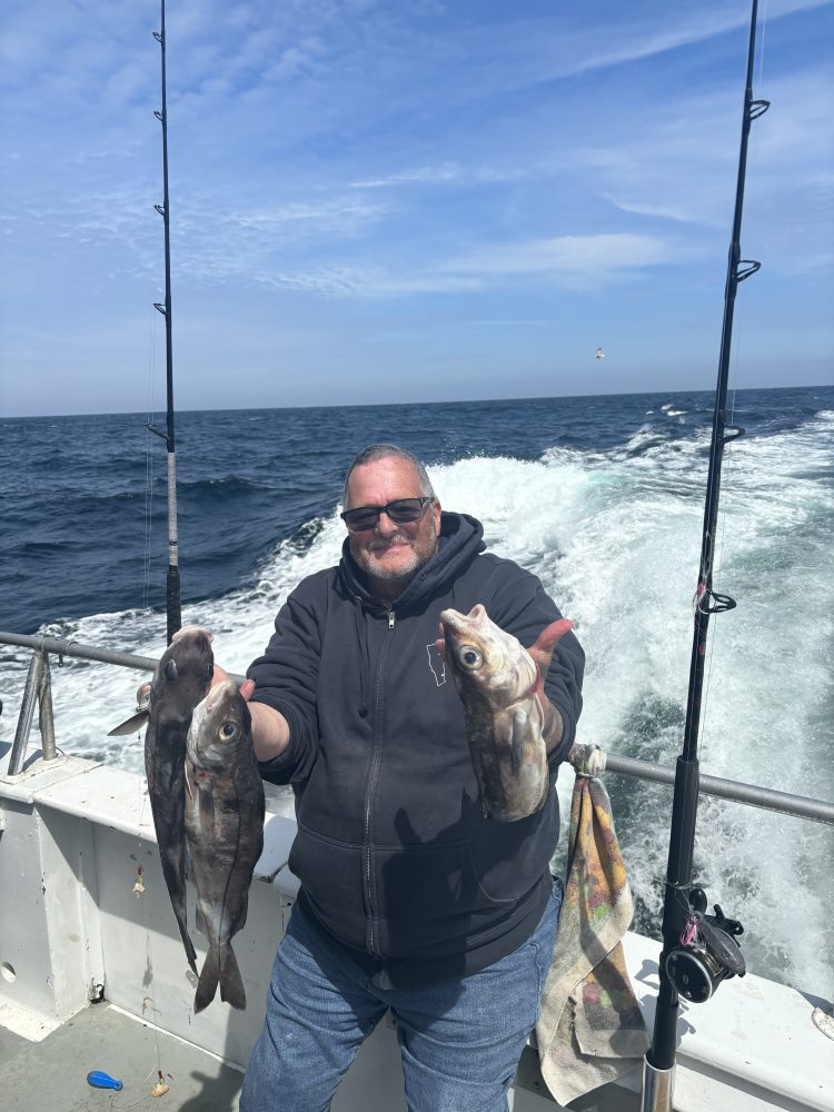 a man holding a fish in the water