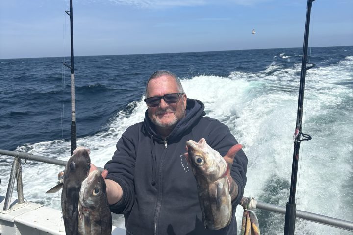 a man holding a fish in the water