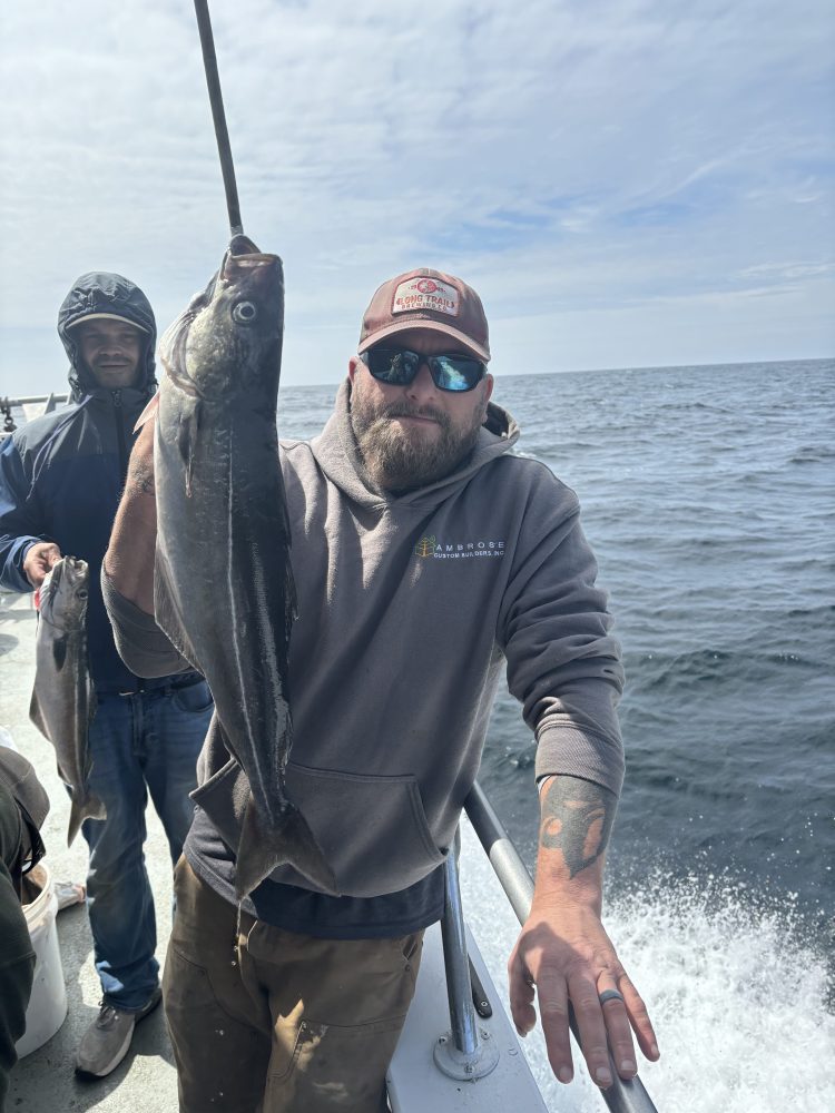 a man holding a fish in the water