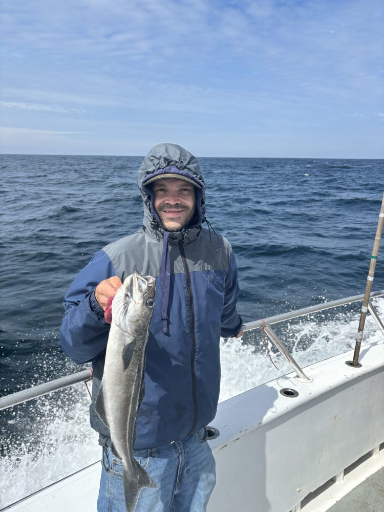 a person holding a fish in the water