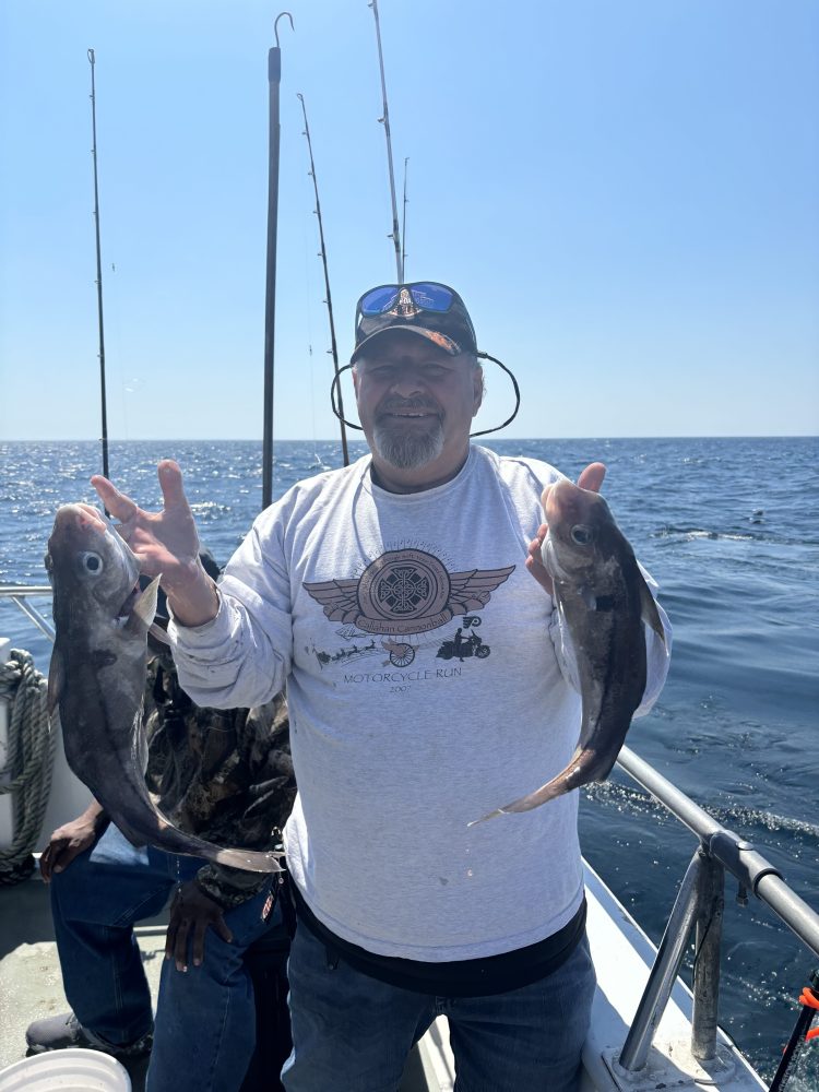 a person holding a fish in the water