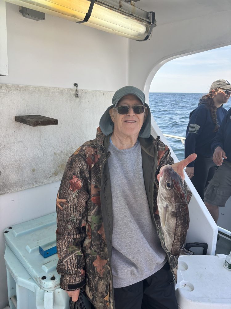 a person holding a fish in the water