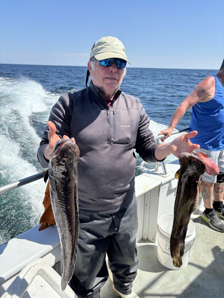 a man holding a fish in the water