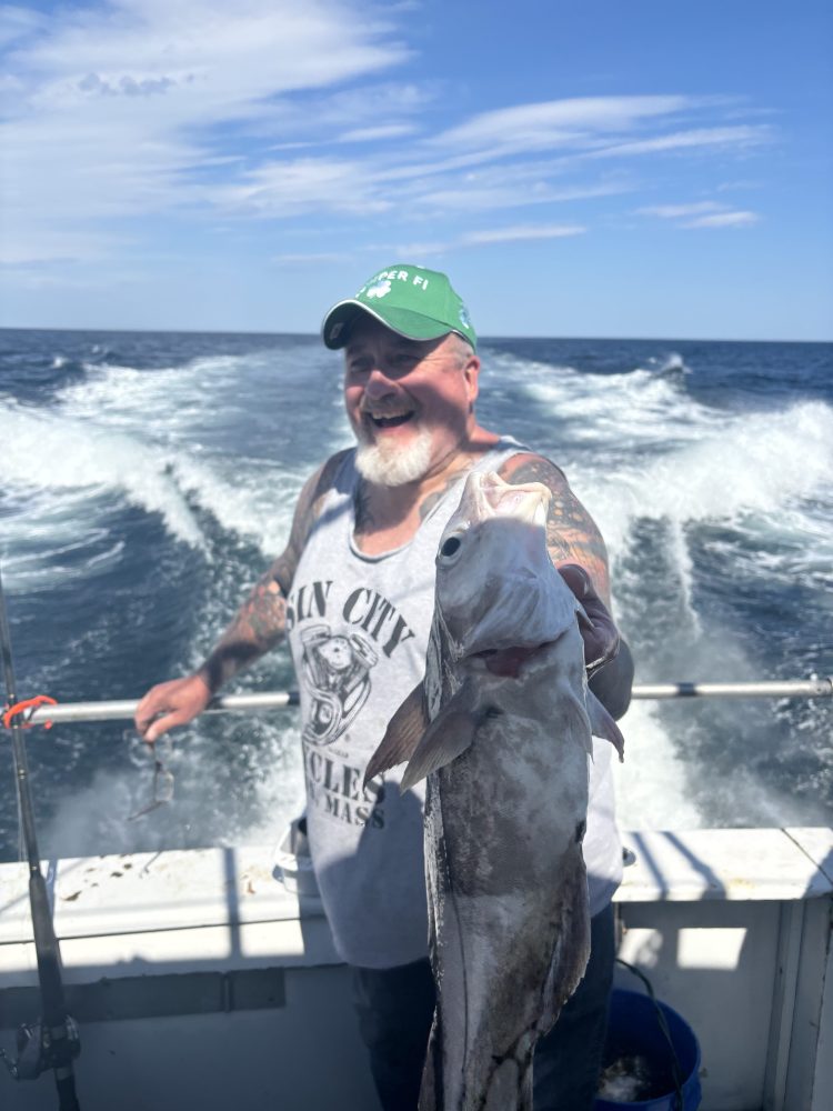 a man holding a fish in the water