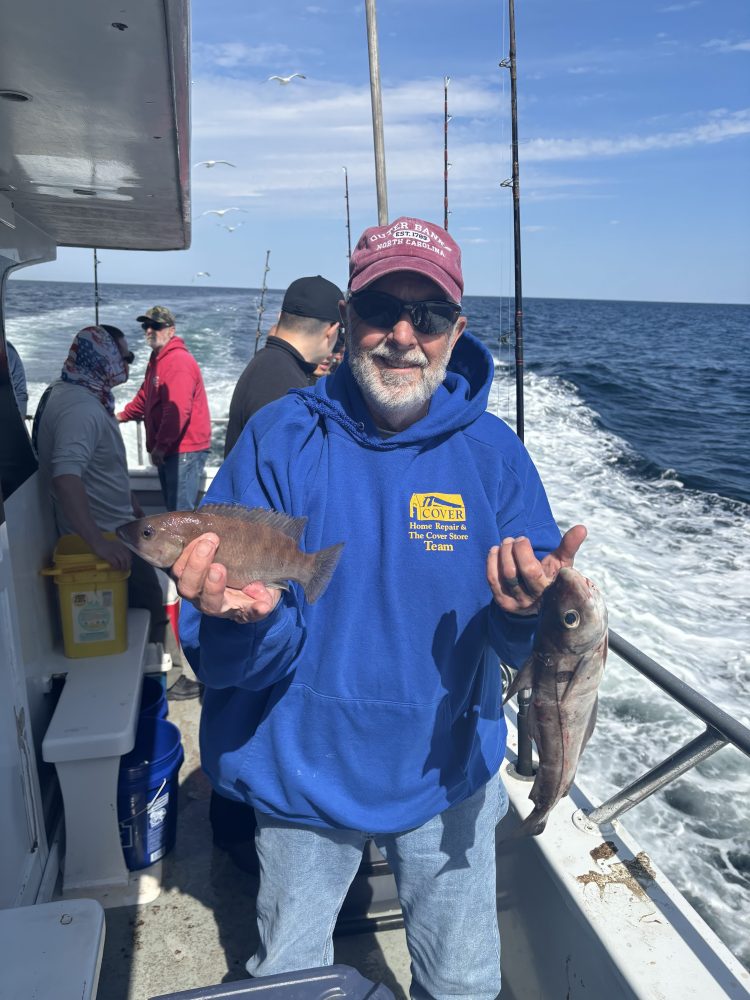 a person holding a fish in the water