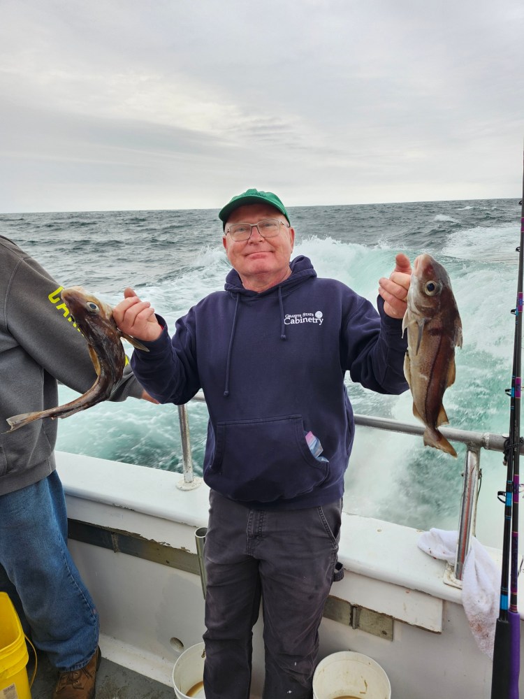 a person holding a fish in the water