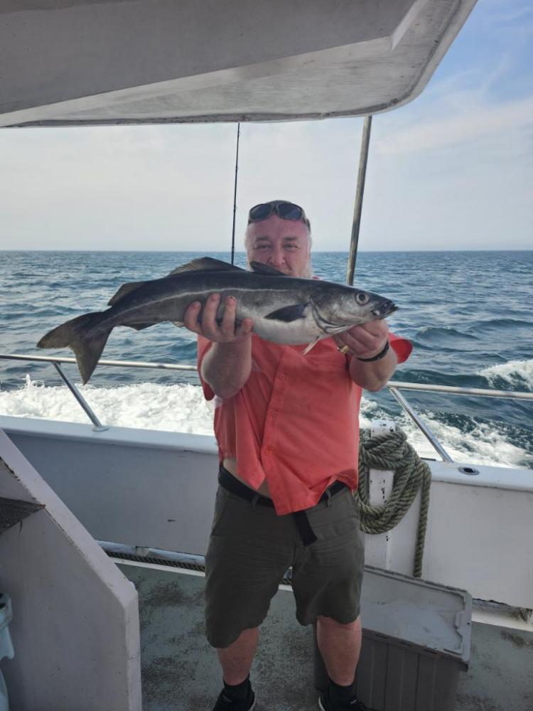 a man holding a fish in the water