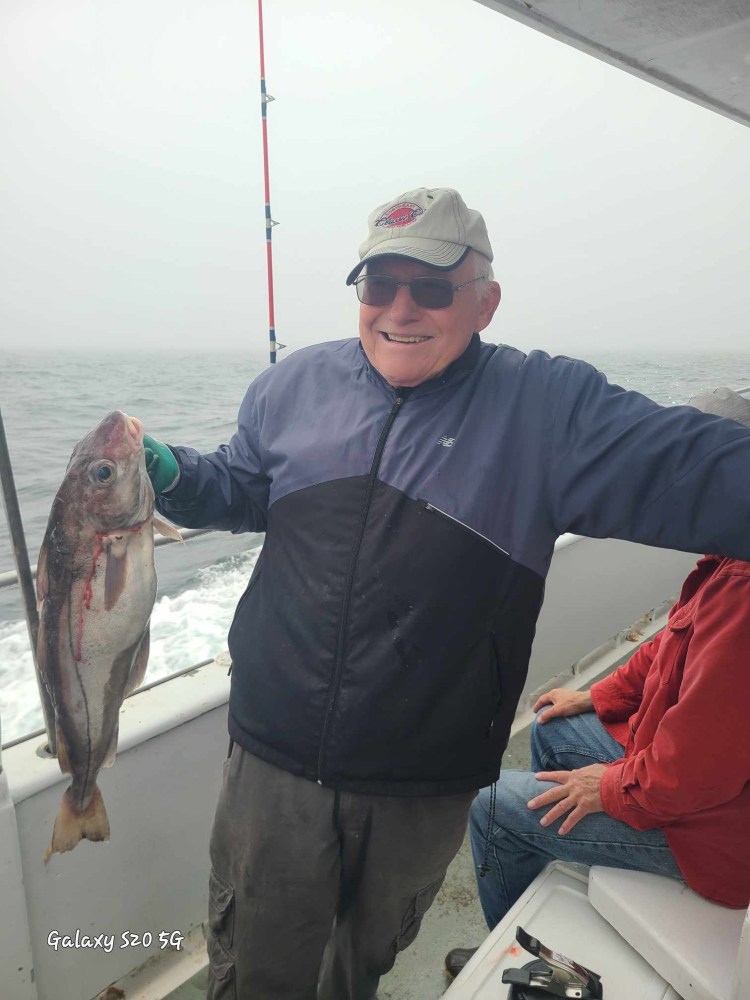 a person holding a fish in the water