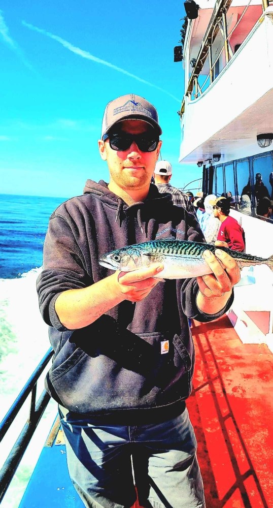 a person holding a fish in the water