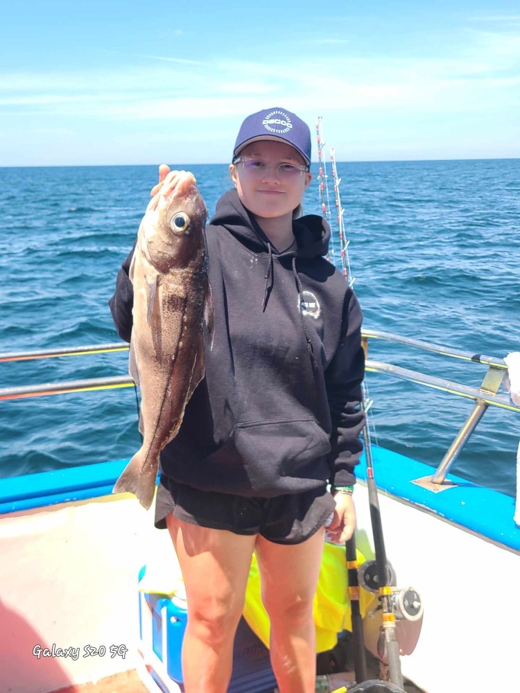 a person holding a fish in the water