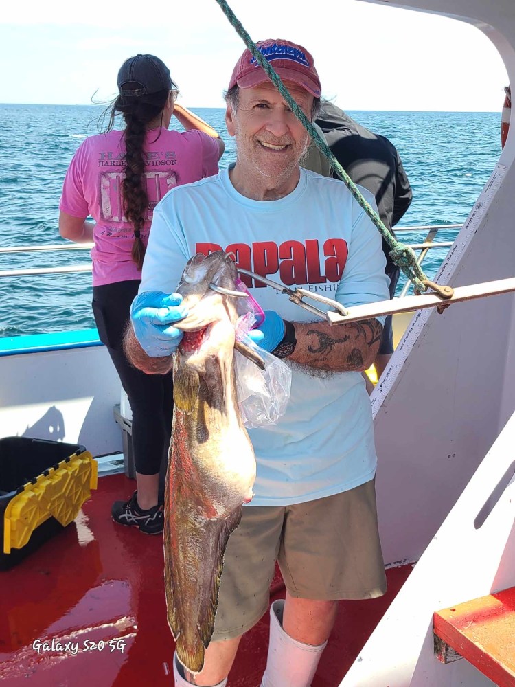 a person holding a fish in the water