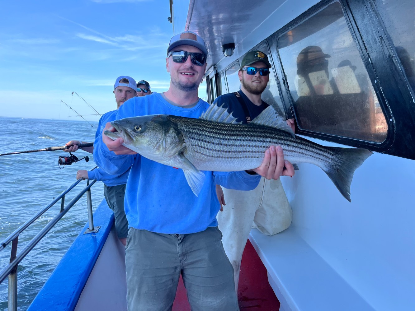 a man holding a fish in the water