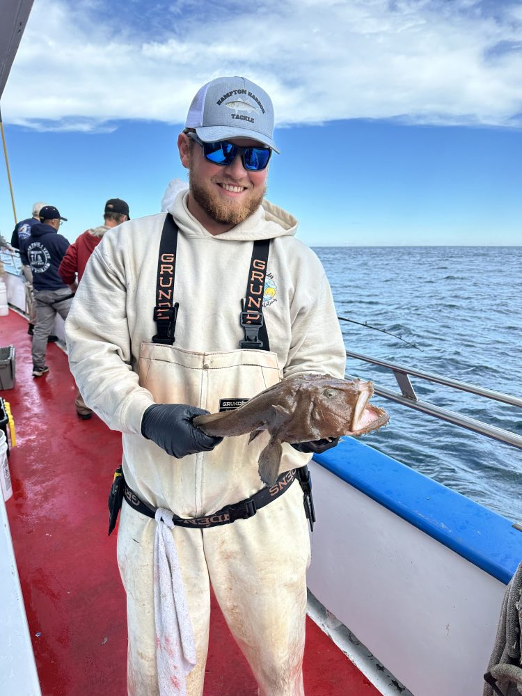 a person holding a fish in the water