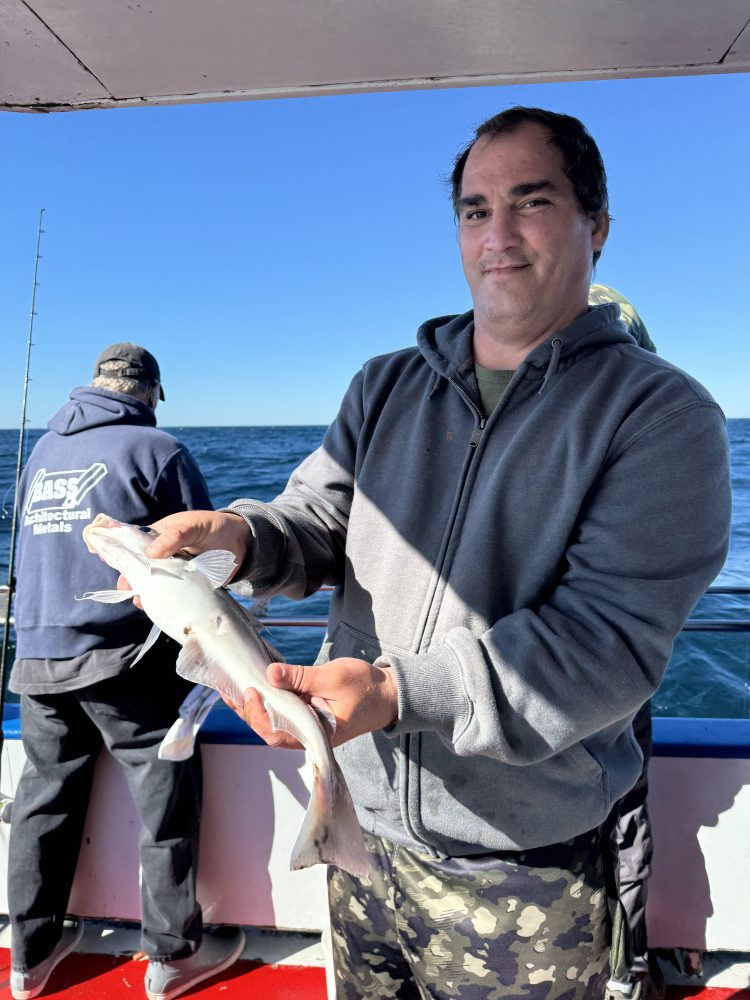 a man holding a fish