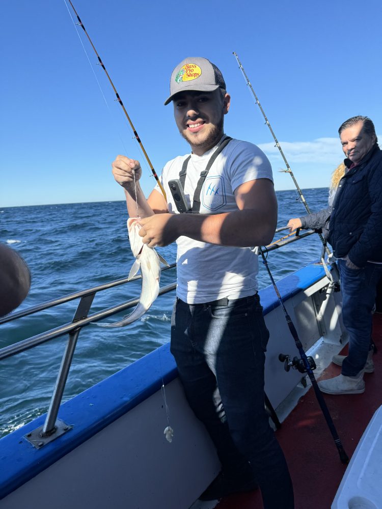 a person standing next to a body of water