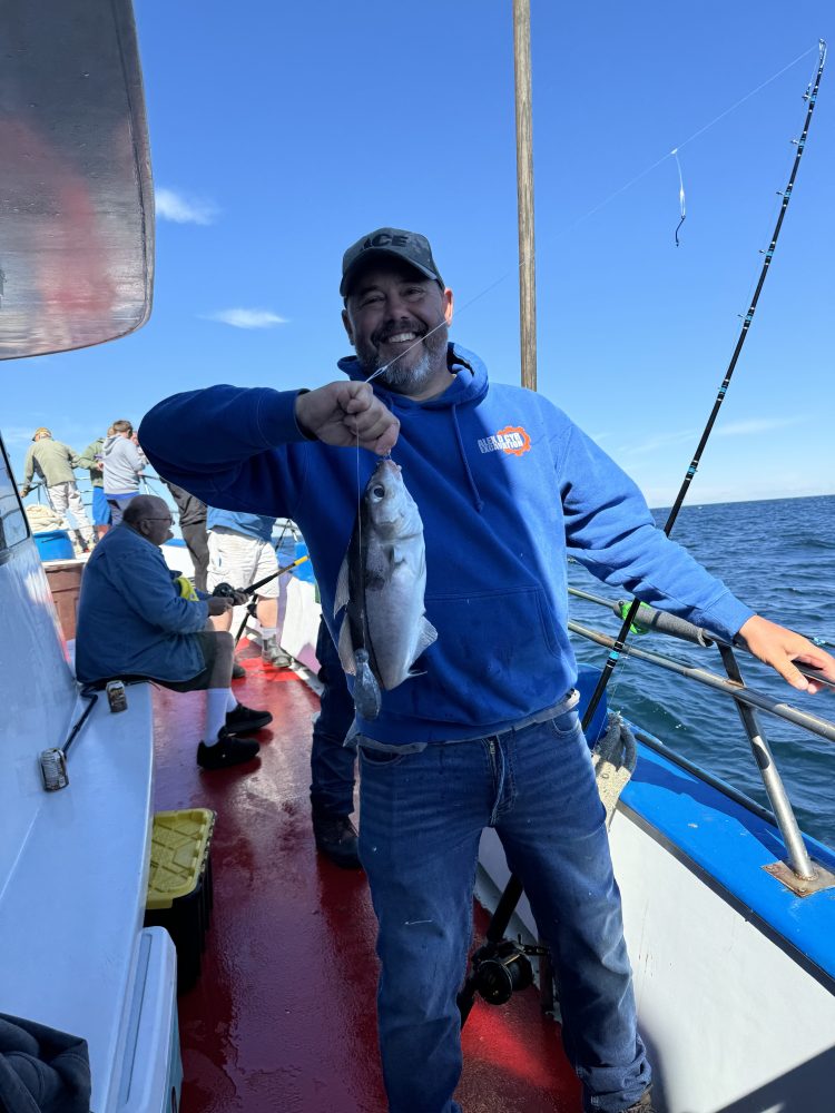 a man standing on a boat in the water