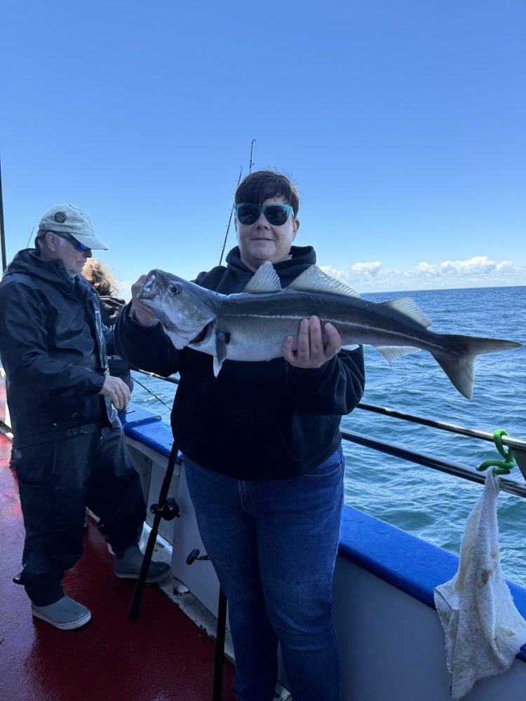 a person holding a fish in the water