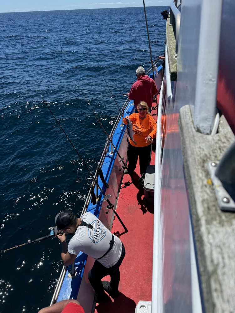 a person riding on the back of a boat in the water