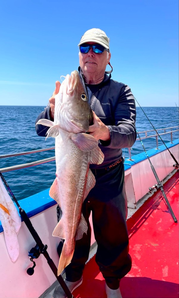 a person holding a fish in the water