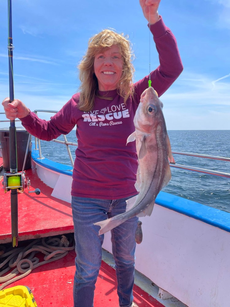 a person holding a fish in the water