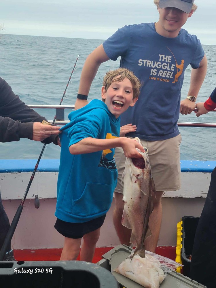 a person holding a fish in the water