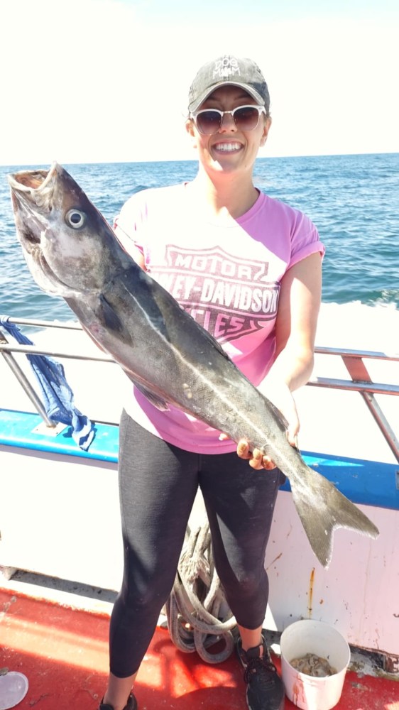 a person holding a fish in the water