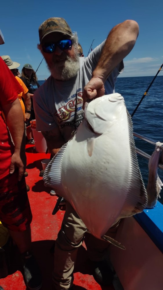 a person holding a fish in the water