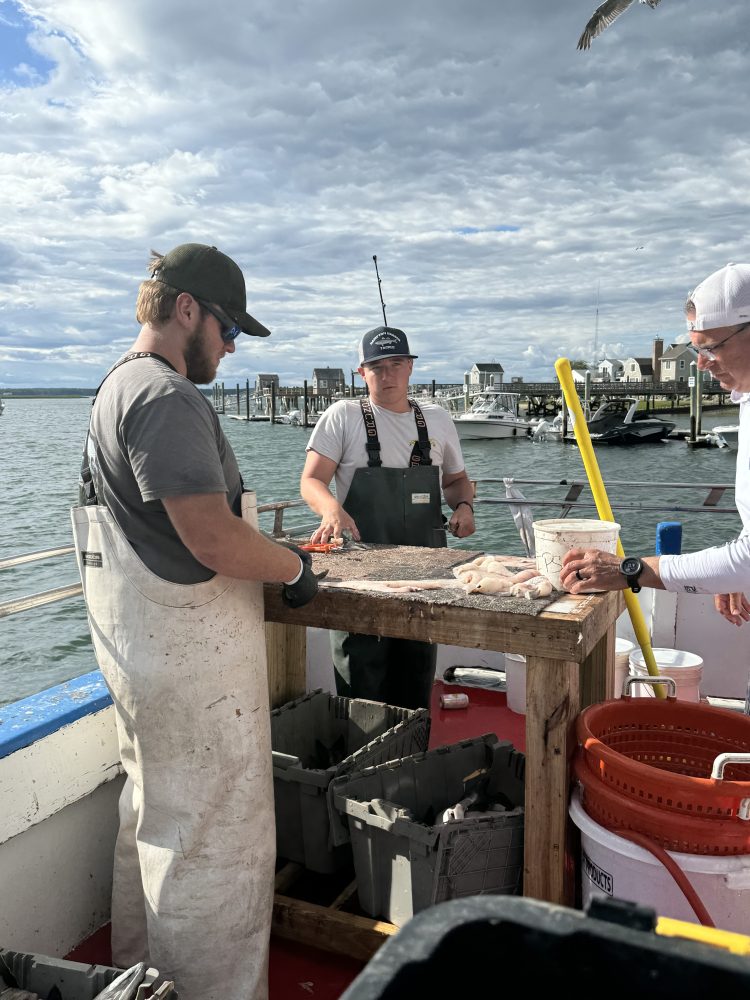 a group of people standing on a boat