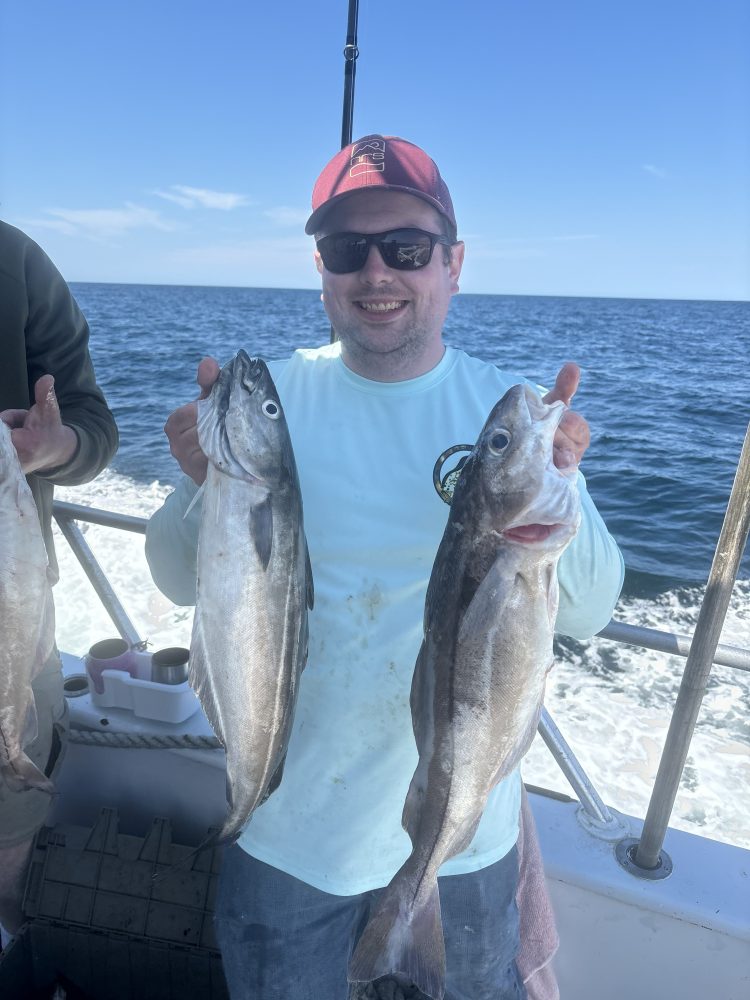 a person holding a fish in the water