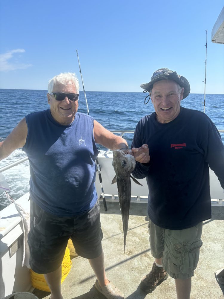 a person holding a fish in the water