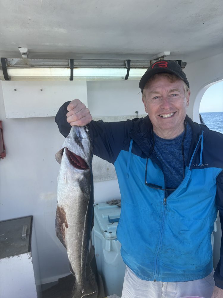 a man holding a fish