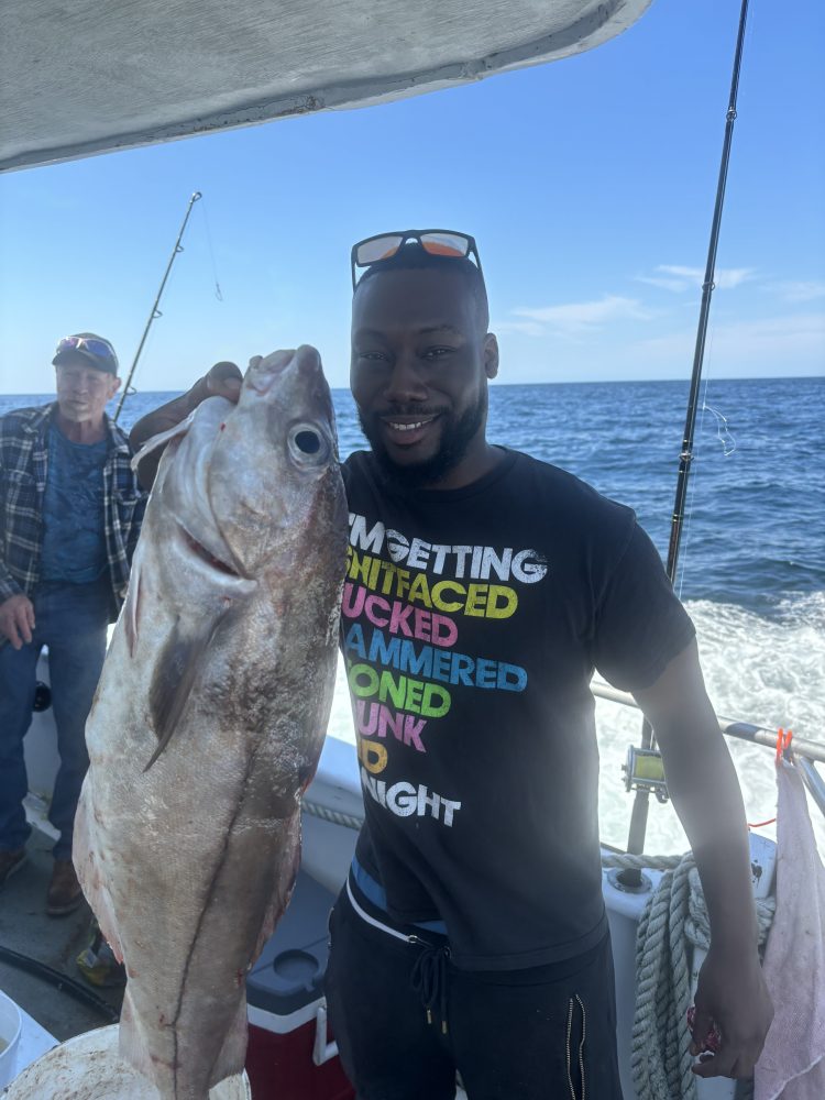 a man holding a fish in the water