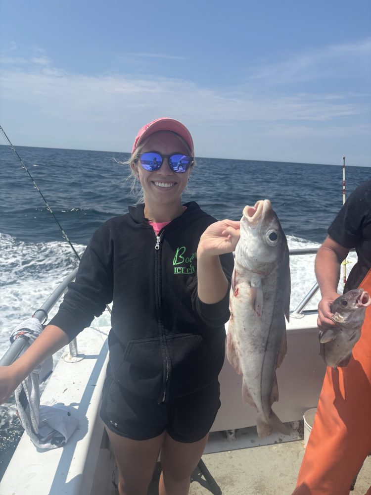 a person holding a fish in the water