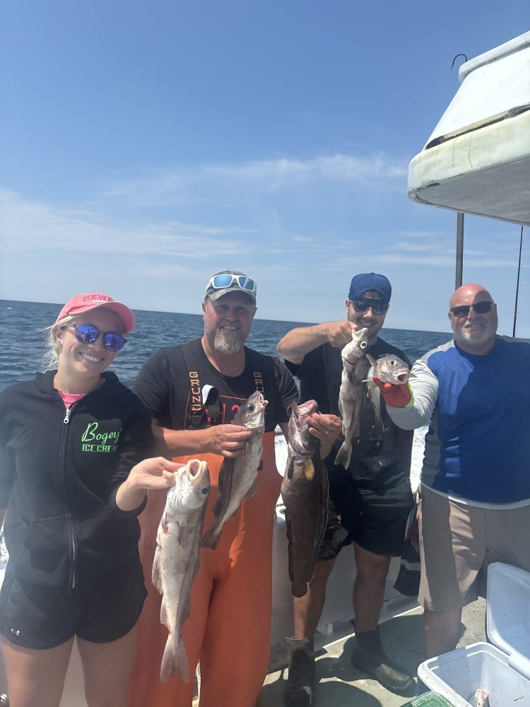 a group of people standing in front of a fish