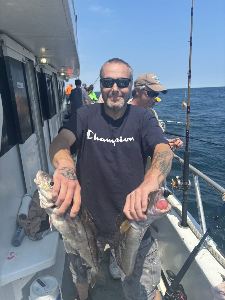 a man holding a fish in the water