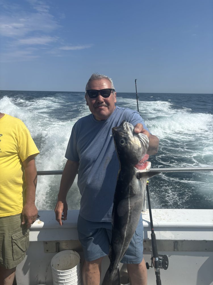 a man holding a fish in the water