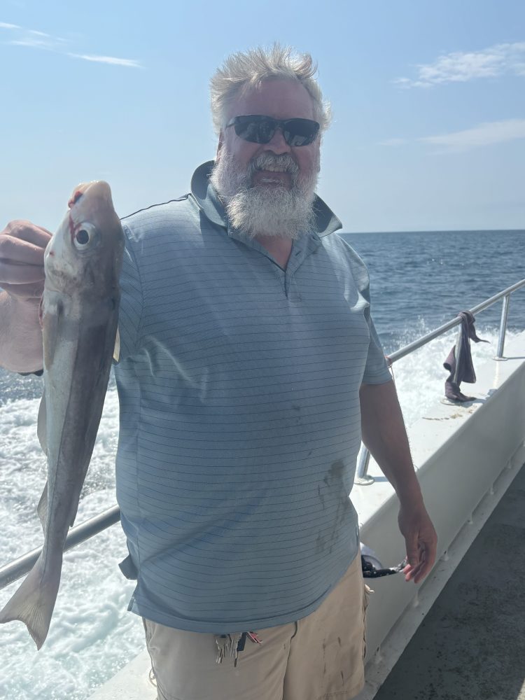 a man holding a fish in the water