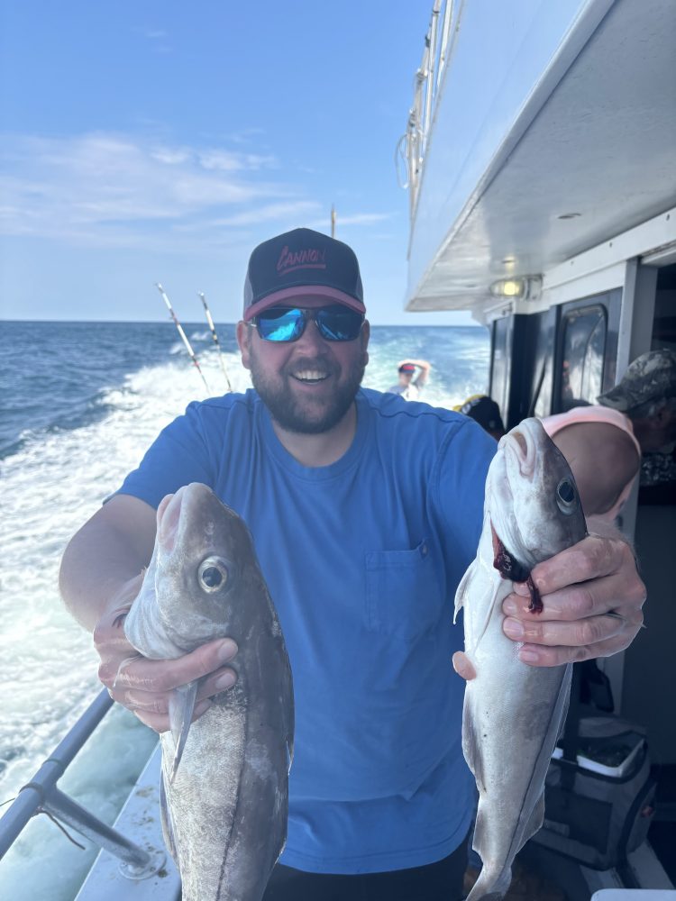 a man holding a fish in the water