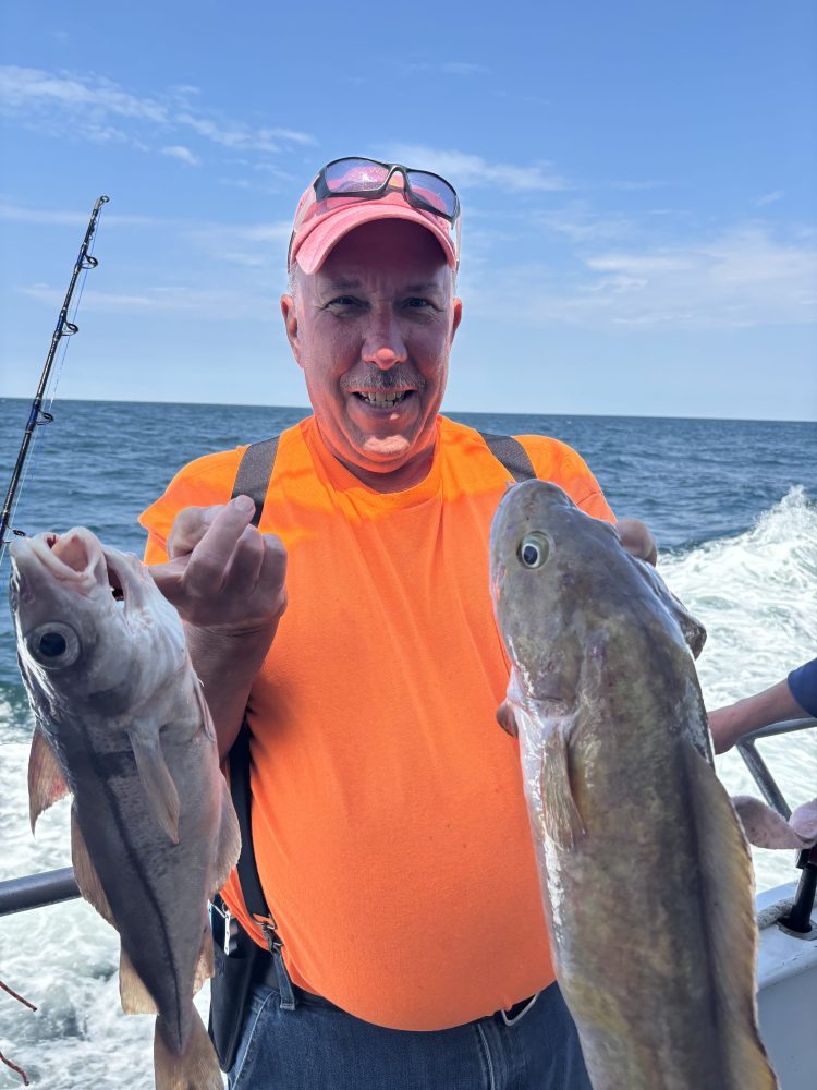 a man holding a fish in the water